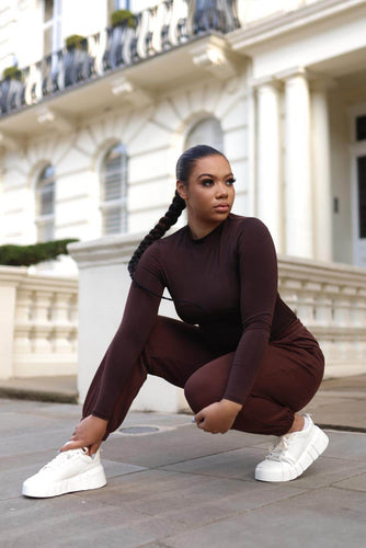 This women&#39;s bodysuit is as stylish as it is comfortable. The chic brown hue pairs effortlessly with solid pants and jeans alike, and the long sleeves will keep you warm during chilly days spent running errands or even waltzing around town.