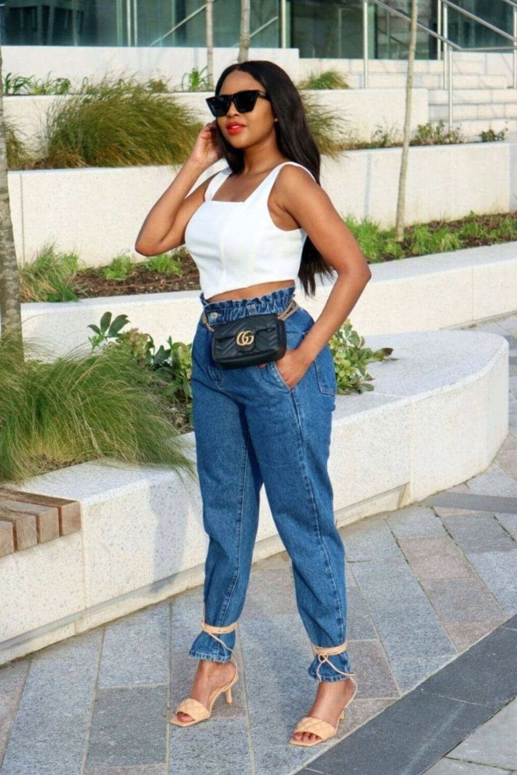 Model effortlessly enhancing her outfit with the elegant and sexy White Corset Top suitable for all events.