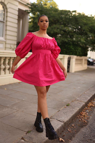 The Pink Poplin Dress Puff-sleeved is a midi length, from the shoulder to the hem. It has a sleeved design with puffy sleeves which adds a unique touch. The fabric is cotton poplin which gives the fabric a nice texture and makes it easier to style or compliment your outfit for that special day or occasion.