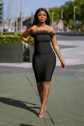 Stunning Knee-Length Black Feather Strapless Dress on model with form-fitting design.