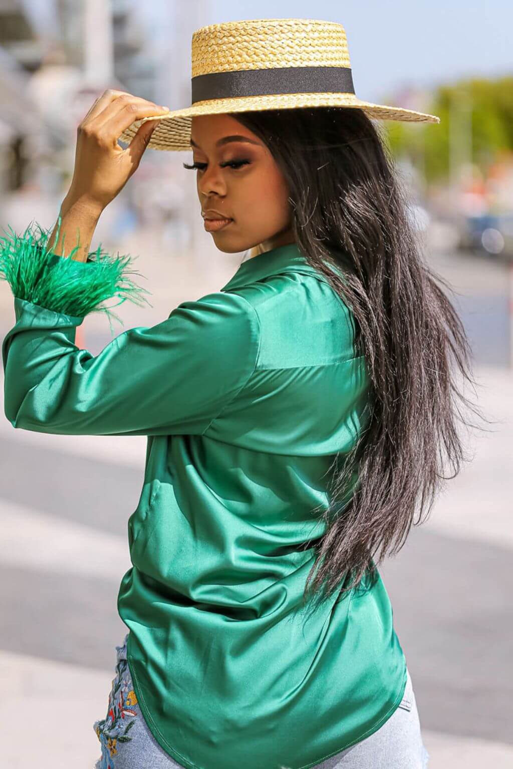 Back view of the Faux Feather Trim Green Blouse, showcasing the unique and stylish faux ostrich feather trim. This blouse is made from comfortable satin material and can be paired with a range of bottoms for a versatile look.